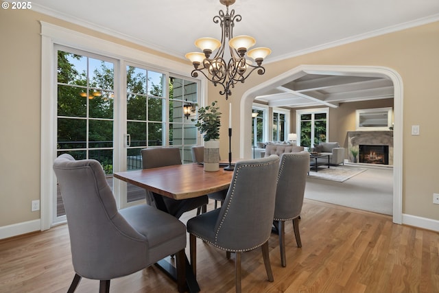3505 SW Beaverton Ave, Portland, OR 97239 - dining area with crown molding, healthy amount of natural light, coffered ceiling, a chandelier, and arched walkways