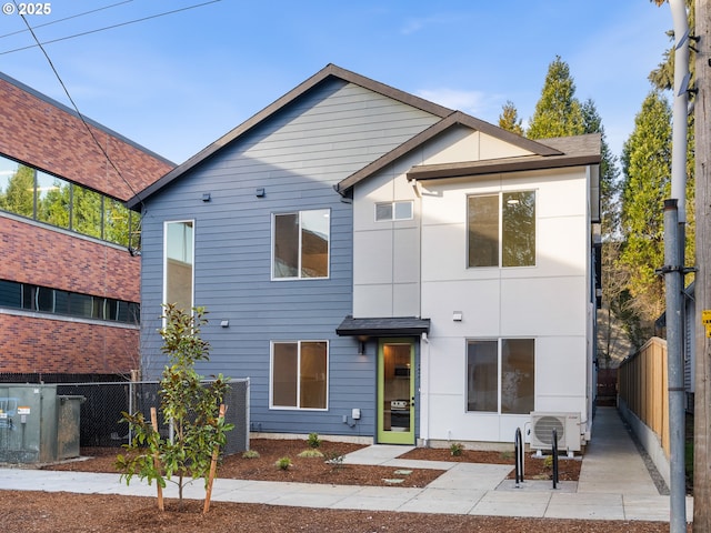 view of front of property featuring ac unit, a patio, and fence