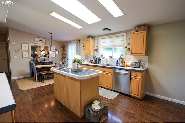 kitchen featuring tile counters, dishwasher, lofted ceiling, dark wood-type flooring, and a sink