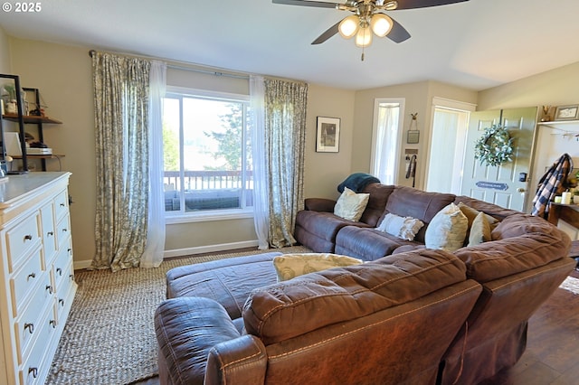 living room with baseboards, a ceiling fan, and wood finished floors