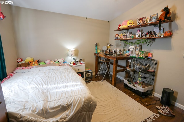 bedroom with baseboards and wood finished floors