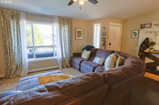 living area featuring ceiling fan, baseboards, vaulted ceiling, and wood finished floors