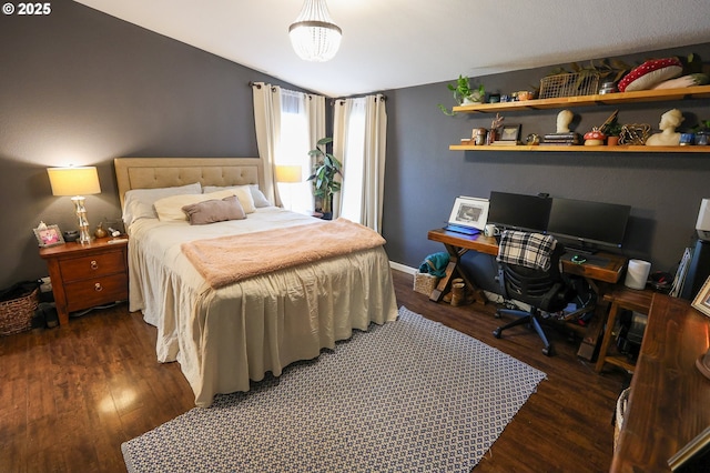 bedroom featuring vaulted ceiling and wood finished floors