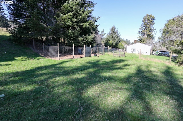 view of yard with fence and a rural view