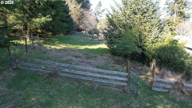 view of gate featuring fence and a lawn