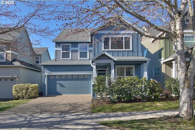 view of front of home with concrete driveway and an attached garage