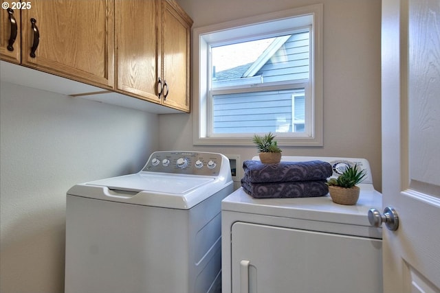 laundry area with washing machine and dryer and cabinet space