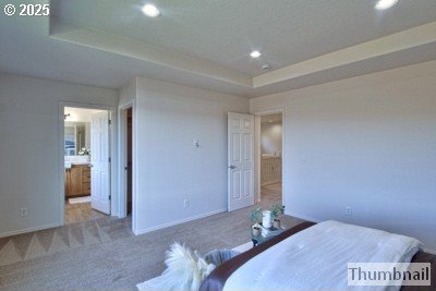 bedroom with connected bathroom, baseboards, carpet floors, recessed lighting, and a raised ceiling