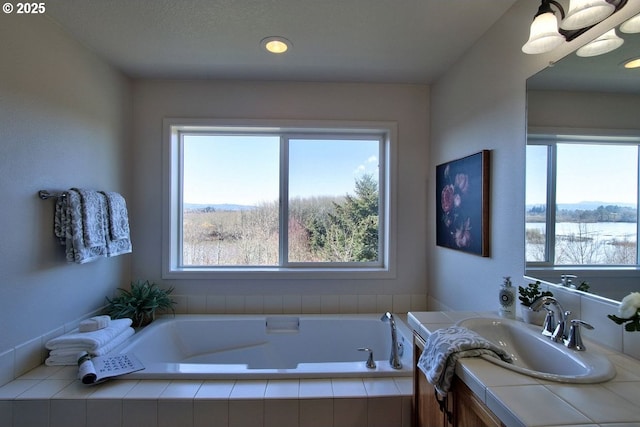 full bath with a bath and vanity