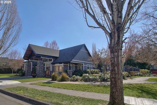 view of side of home featuring a yard and board and batten siding