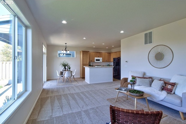 living room with recessed lighting, visible vents, light carpet, and baseboards