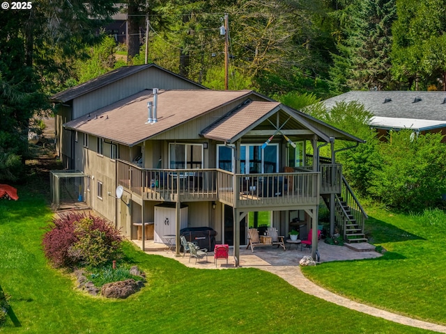 back of house with a yard, a patio area, a hot tub, and a deck
