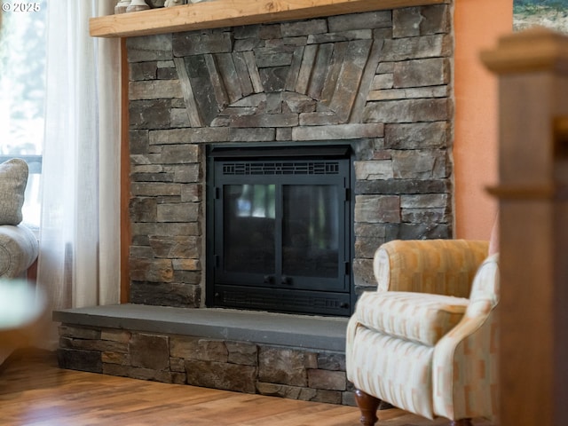 interior details featuring wood finished floors and a fireplace