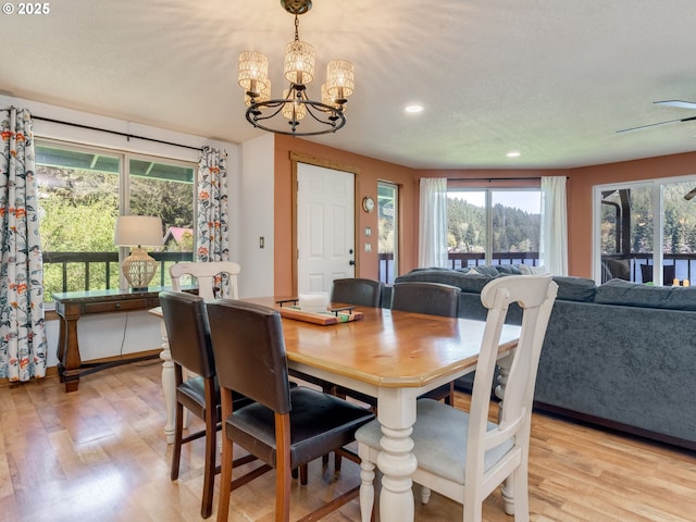 dining space featuring an inviting chandelier, light wood-type flooring, and recessed lighting