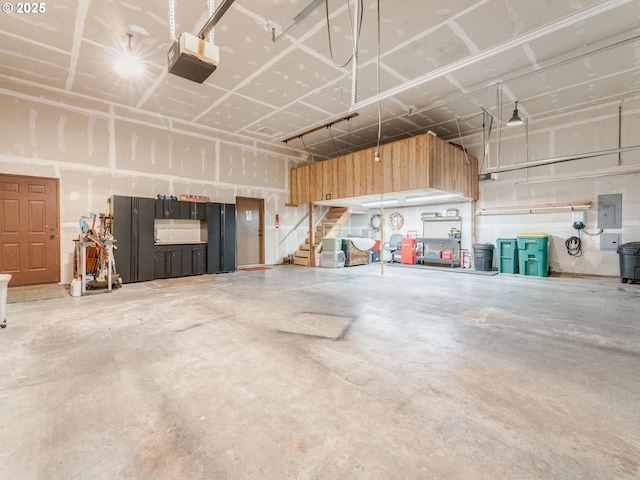 garage featuring electric panel and a garage door opener