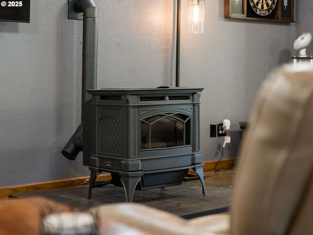 room details with a wood stove and baseboards
