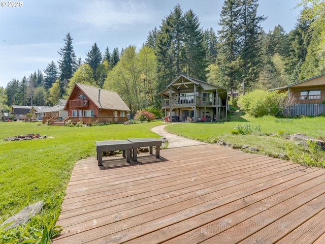 wooden deck with a yard and stairway