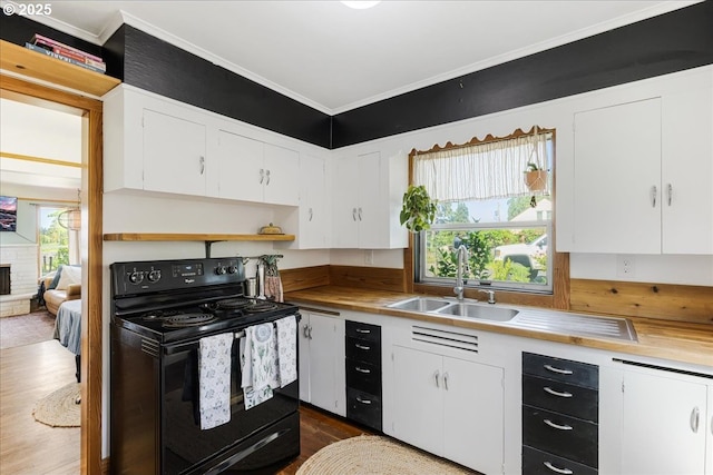 3310 N St N, Vancouver, WA 98663 - kitchen featuring black / electric stove, a sink, dark wood finished floors, white cabinets, and ornamental molding