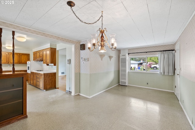 1627 NE 143rd Ave, Portland, OR 97230 - unfurnished dining area with wallpapered walls, a chandelier, and baseboards