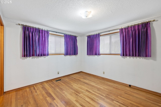 1627 NE 143rd Ave, Portland, OR 97230 - unfurnished room with wood finished floors, a textured ceiling, and baseboards