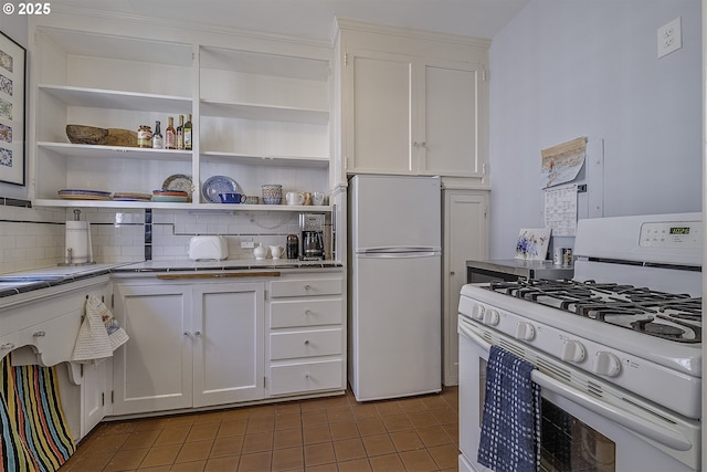 kitchen with decorative backsplash, open shelves, white appliances, and white cabinets