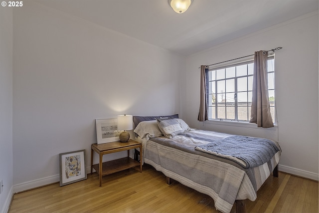 bedroom featuring light wood-type flooring and baseboards