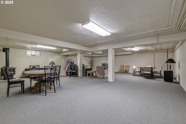 carpeted dining space featuring a textured ceiling