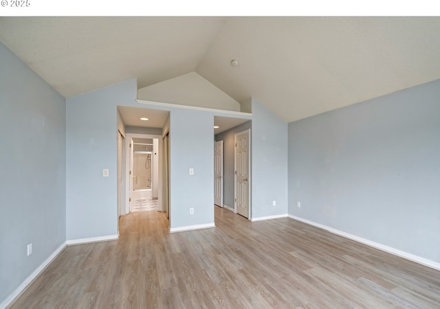 unfurnished room with light wood-type flooring, lofted ceiling, baseboards, and recessed lighting