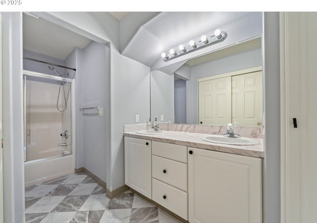 bathroom with marble finish flooring, double vanity, shower / washtub combination, and baseboards