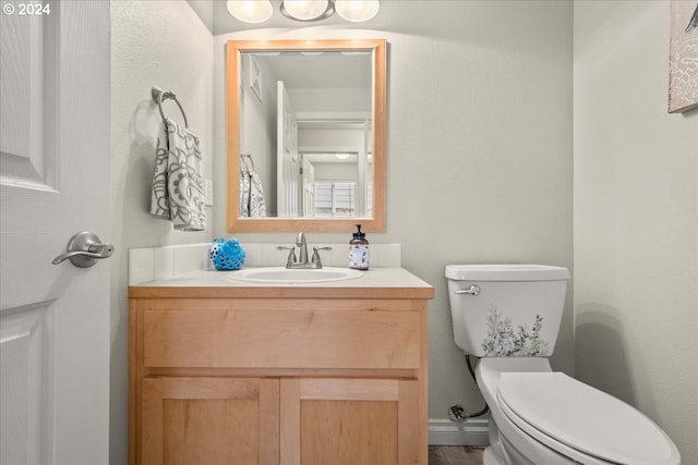bathroom featuring vanity and toilet