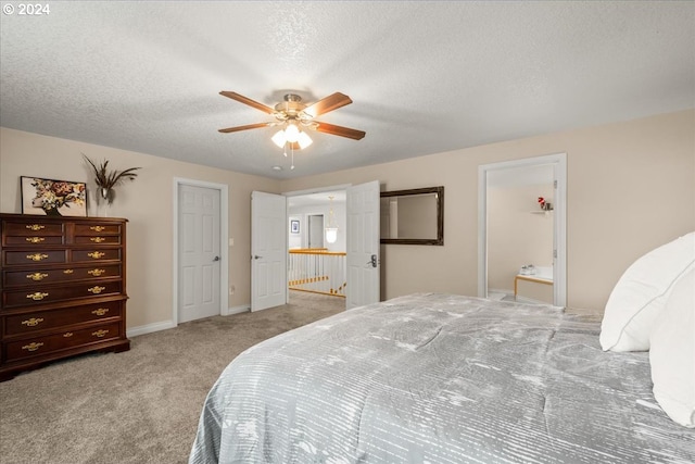 bedroom with ceiling fan, light colored carpet, a textured ceiling, baseboards, and ensuite bathroom