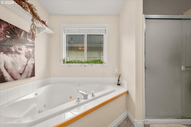 full bathroom with a shower stall and a tub with jets