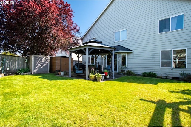 rear view of house featuring a gazebo, a patio, a shed, an outdoor structure, and a yard
