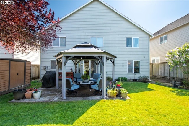 rear view of house featuring a fenced backyard, a gazebo, an outdoor hangout area, and a patio area