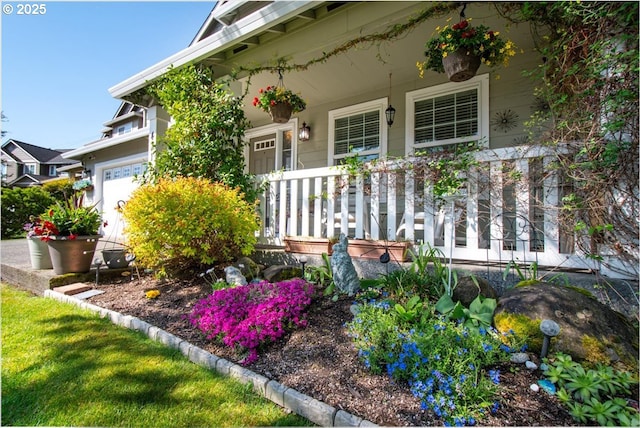 property entrance with a porch and a garage