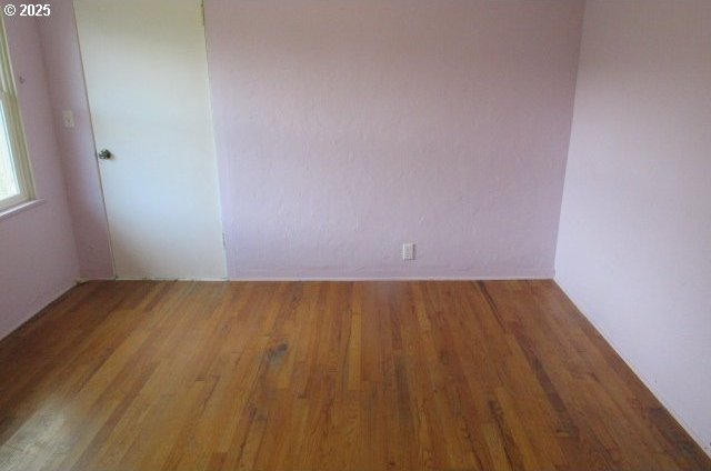 spare room with wood finished floors