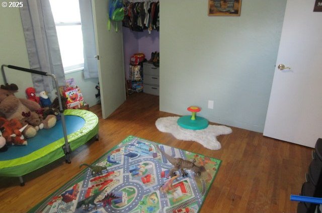 bedroom with a closet and wood finished floors