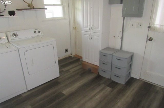 washroom featuring electric panel, cabinet space, dark wood-type flooring, and washing machine and dryer