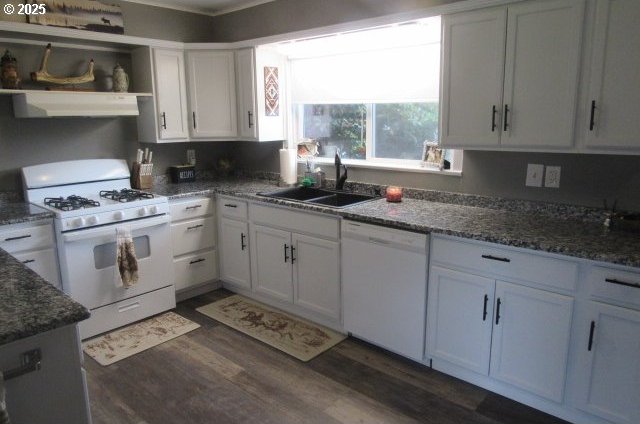 kitchen featuring white appliances, extractor fan, a sink, dark wood-type flooring, and white cabinets