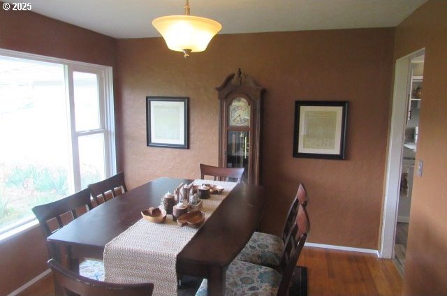 dining area featuring wood finished floors and baseboards