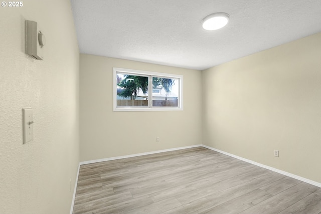 8419 SE Yamhill St, Portland, OR 97216 - spare room featuring wood finished floors, a textured ceiling, and baseboards