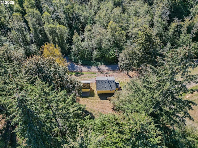 birds eye view of property with a view of trees