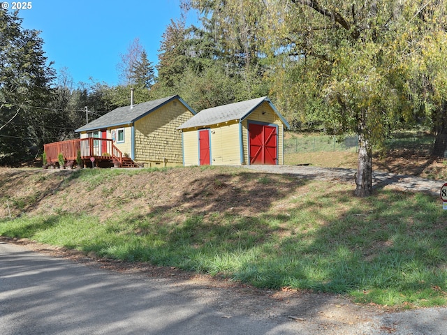 exterior space with an outbuilding, a storage unit, and a deck