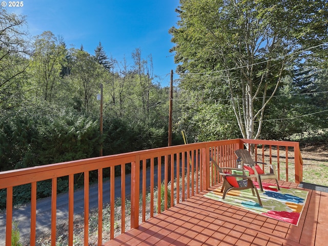 wooden terrace with a view of trees