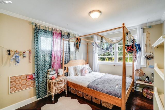 bedroom with ornamental molding, wood finished floors, and baseboards