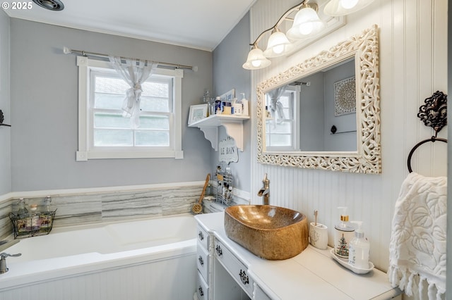 full bath with vanity and a bath