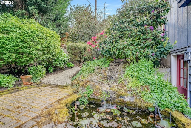 view of yard featuring a garden pond