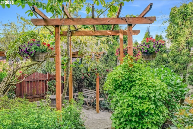 view of yard featuring fence and a pergola