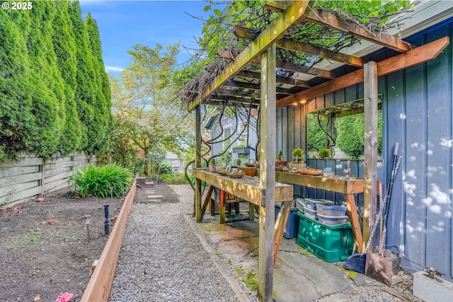 fenced backyard featuring a pergola
