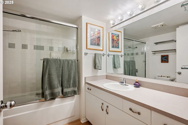 6665 W Burnside Rd, Portland, OR 97210 - full bathroom featuring vanity and bath / shower combo with glass door